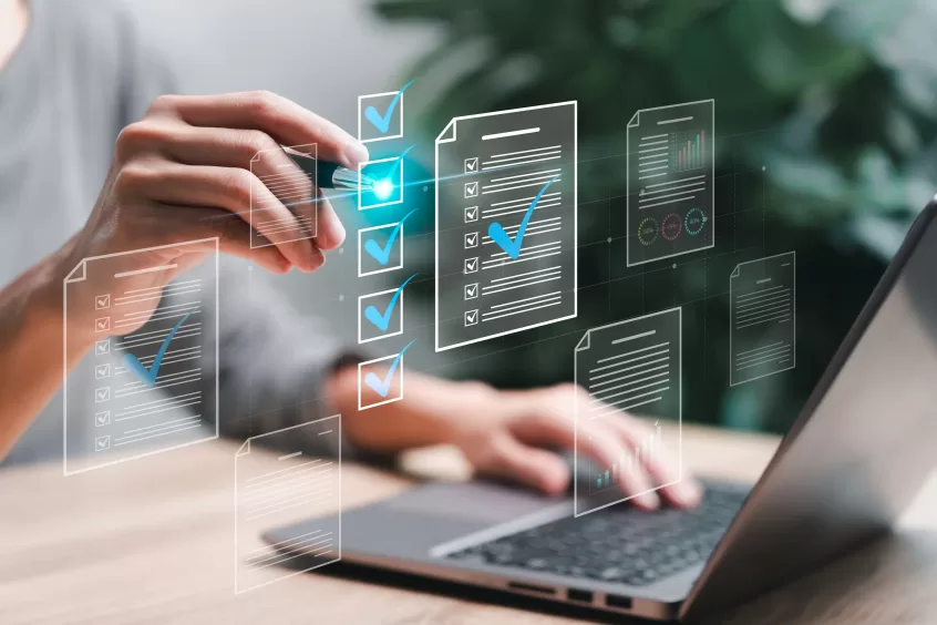 person at a desk selecting check mark